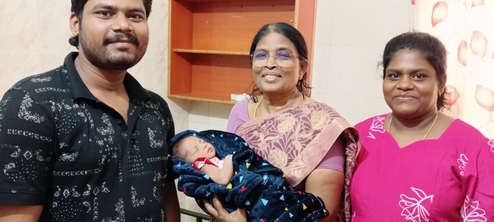 Dr. Alagusundararammal S with a newborn and family